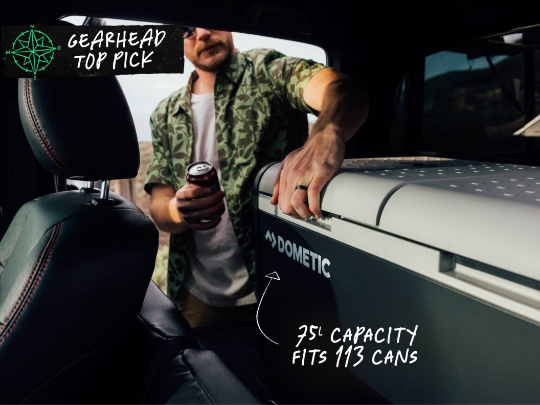 A man gets ready to open a cooler inside a car. Text overlay reads: Gearhead Top Pick, 75L capacity fits 113 cans.